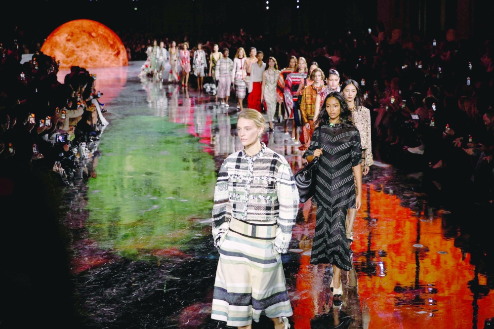 Models present creations by Chanel at the end of the Women Ready-to-wear Spring-Summer 2026 collection as part of the Paris Fashion Week, at the Grand Palais in Paris on October 6, 2025. (Photo by Anne-Christine POUJOULAT / AFP)
