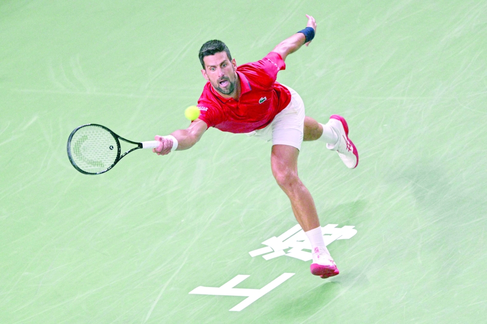 Serbia's Novak Djokovic hits a return to Belgium's Zizou Bergs during their quarterfinal men's singles match at the Shanghai Masters tennis tournament in Shanghai. — AFP