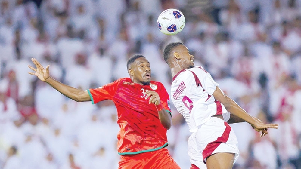 Oman and Qatar players in action.