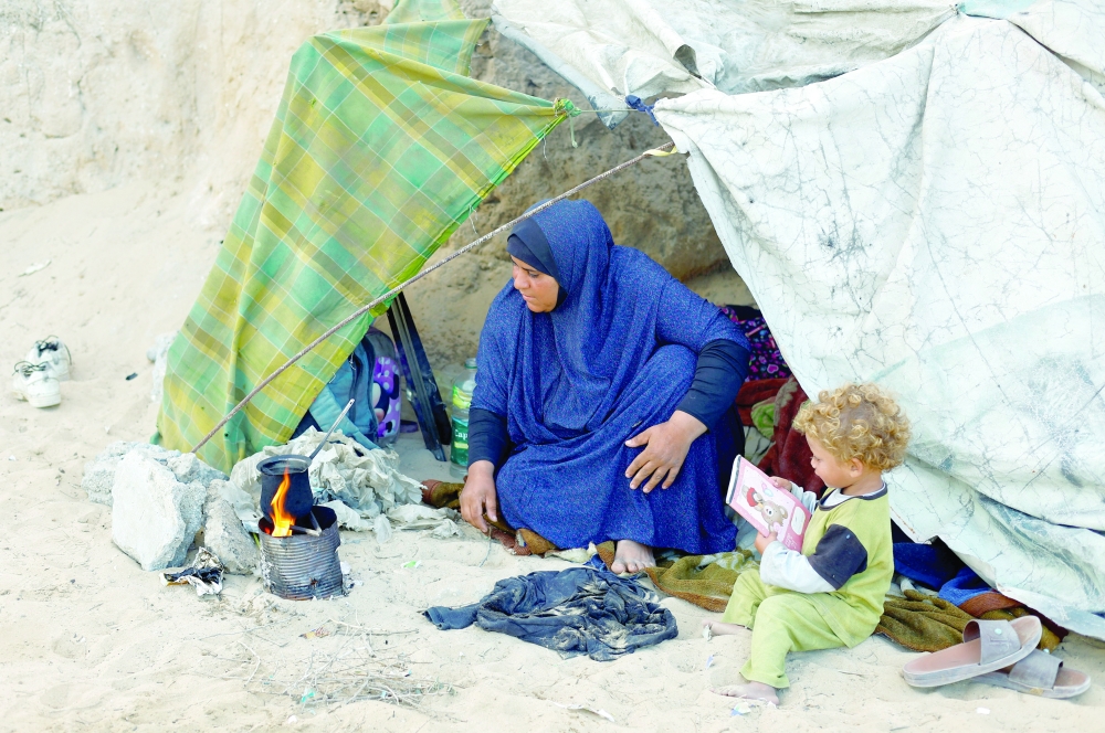 Displaced Palestinians take shelter inside their tents, in central Gaza. — Reuters