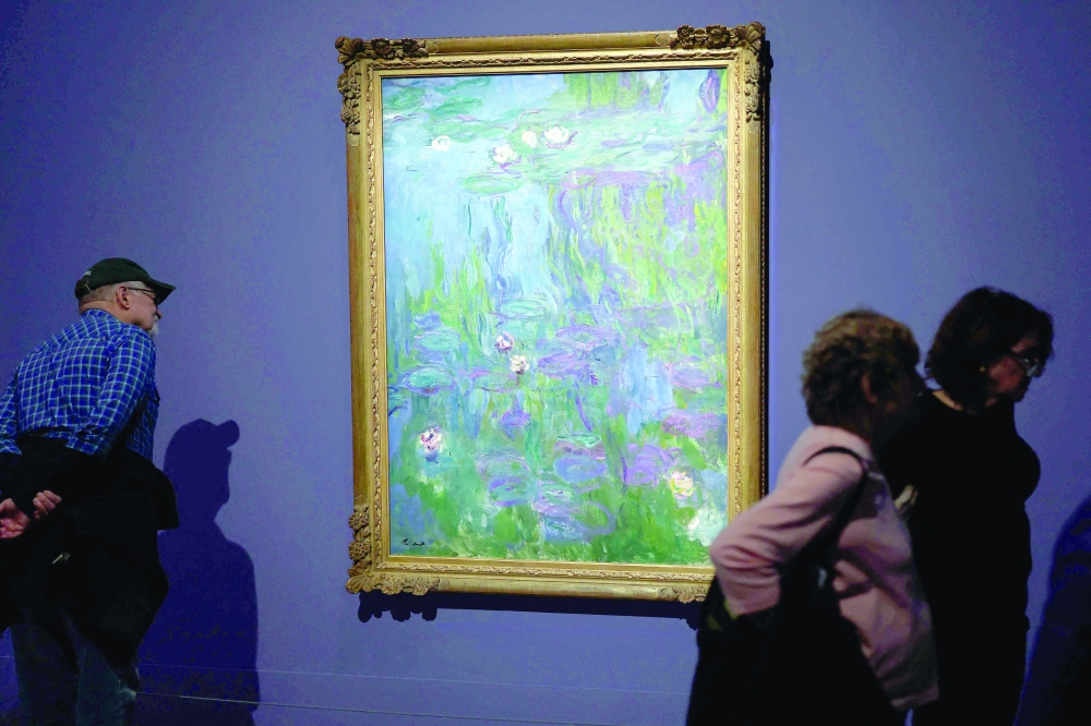 People view a painting by French artist Claude Monet on display at the "Monet and Venice" exhibition at the Brooklyn Museum in Brooklyn, New York, on Saturday. — AFP