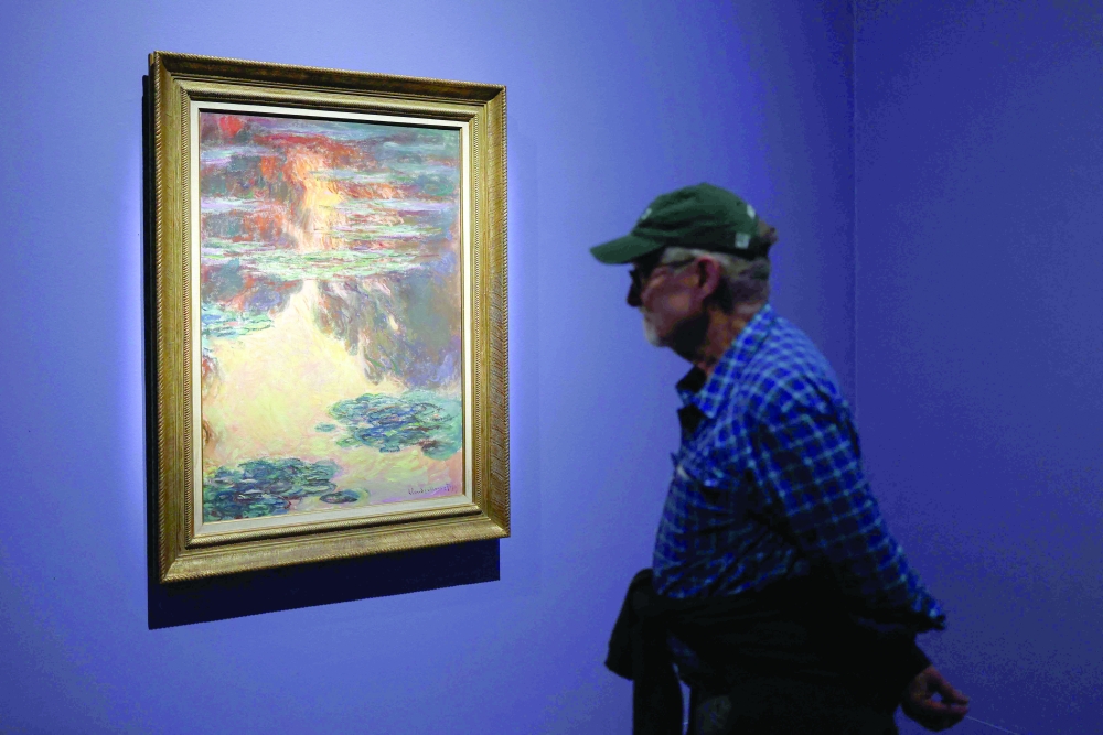 A person views a painting by French artist Claude Monet on display at the "Monet and Venice" exhibition at the Brooklyn Museum in Brooklyn, New York, on Saturday. — AFP