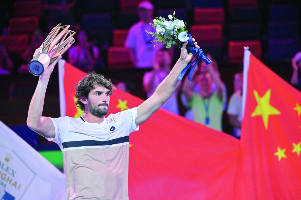 Monaco's Valentin Vacherot celebrates with the trophy after his victory against France's Arthur Rinderknech during the men's singles final at the Shanghai Masters tennis tournament in Shanghai. — AFP