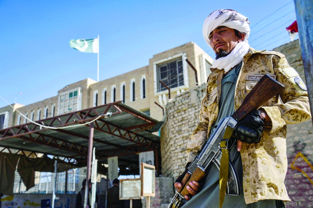An armed Taliban security personnel stands guard near the closed gate of the border crossing between Afghanistan and Pakistan at Spin Boldak district in Kandahar province. — AFP