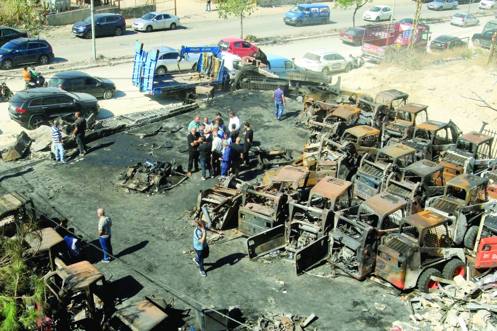 People stand at the site of an overnight Israeli strike in Lebanese village of Al Msayleh. — AFP