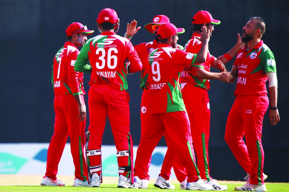 Oman celebrates after key UAE wicket of Mohammed Waseem.