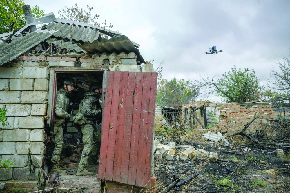 Infantry recruits protect against a simulated drone attack, in eastern Ukraine. — AFP