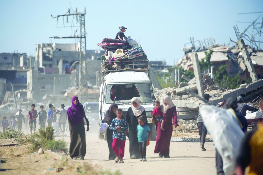 Displaced Palestinians return to their homes in the Al Zahra area, north of the Nuseirat refugee camp. — AFP