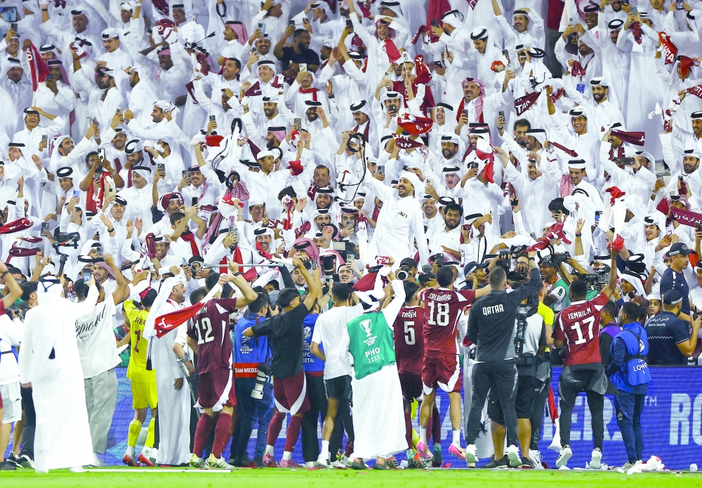 Qatar team members celebrate with fans after qualifying for the Fifa World Cup. — Reuters