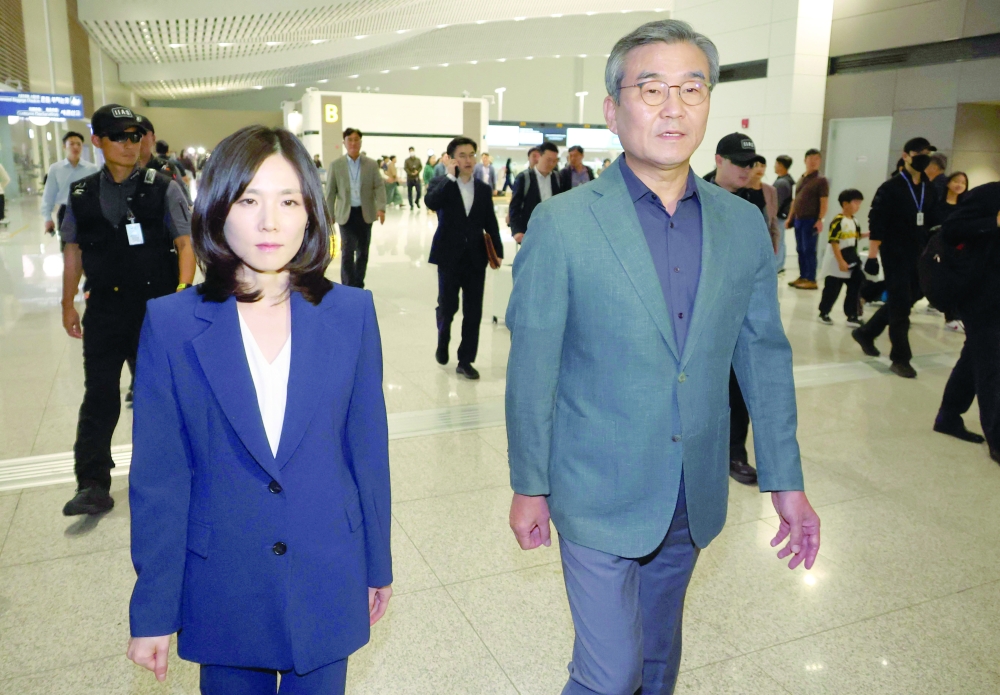 South Korea's Second Vice Foreign Minister Kim Jin-a (L) and Park Sung-joo (R), the head of the National Investigation Headquarters of the National Police Agency, walk as they depart for Cambodia. — AFP