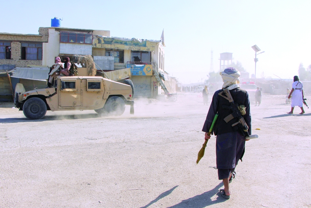 Afghan fighters patrol near the Afghanistan-Pakistan border in Spin Boldak. — Reuters