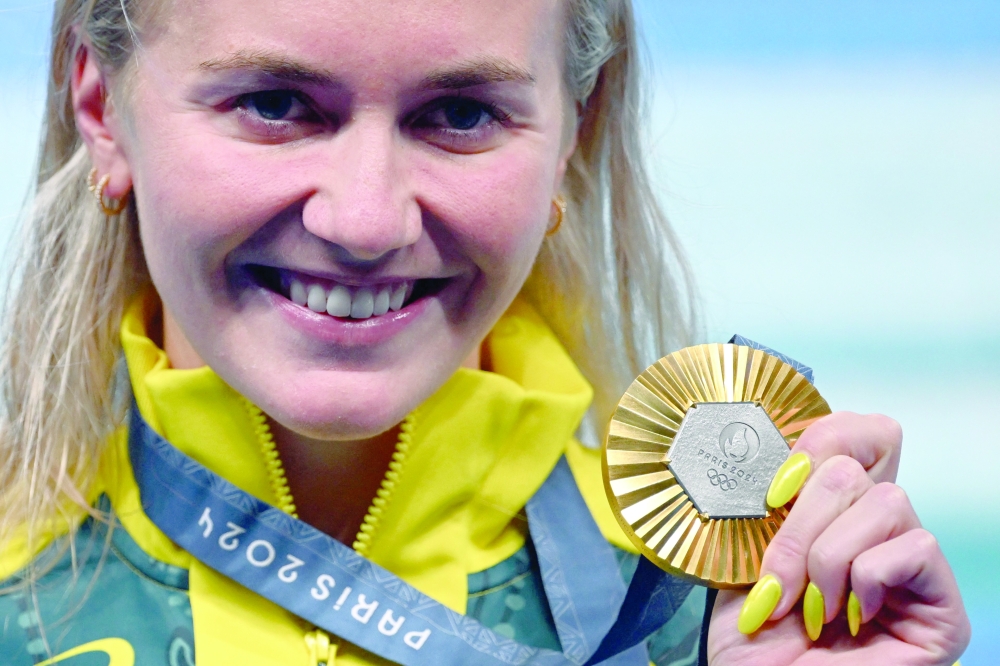 (FILES) Gold medallist Australia's Ariarne Titmus poses with her medal following the women's 400m freestyle swimming event at the Paris 2024 Olympic Games at the Paris La Defense Arena in Nanterre, west of Paris, on July 27, 2024. Four-time Olympic gold medallist Ariarne Titmus announced her immediate retirement from swimming on October 16, 2025, calling it a "really tough" decision as she was lauded as "a living legend". 