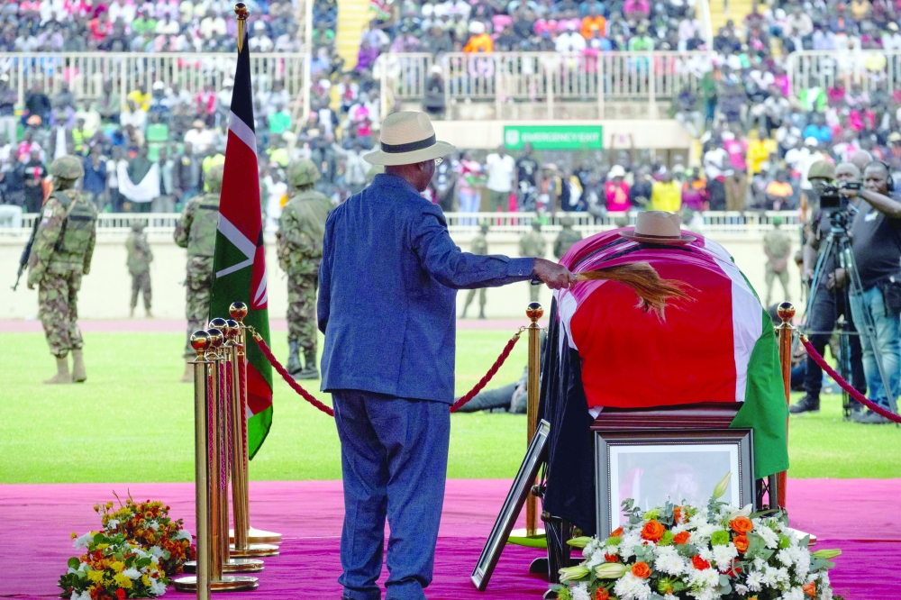 Oburu Odinga brother of Kenya's opposition leader and former Prime Minister Raila Odinga gestures near his coffin during his State Funeral at Nyayo Stadium, in Nairobi. — AFP