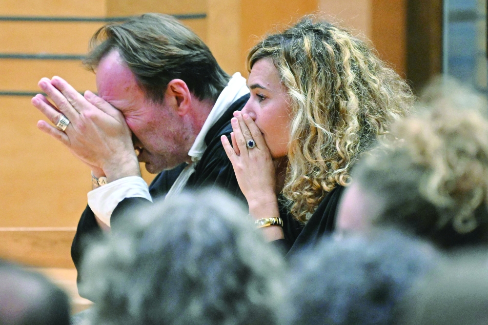 Alexandre Martin (L) and Emmanuelle Franck, lawyers for defendant Cedric Jubillar, wait for the verdict of their client's trial for the murder of his wife Delphine in the courtroom of the Tarn Assize Courthouse in Albi, southwestern France. — AFP