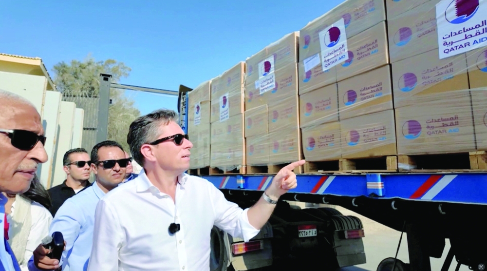 UN Under-Secretary-General for Humanitarian Affairs and Emergency Relief Coordinator, Tom Fletcher points at a truck loaded with humanitarian aid as it is on its way to Gaza, at Rafah Crossing at the Egypt-Gaza border, in Egypt. — Reuters