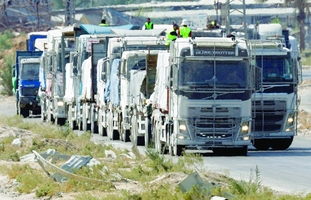 Trucks carry aid for Palestinians in Khan Yunis, in the southern Gaza Strip. — Reuters