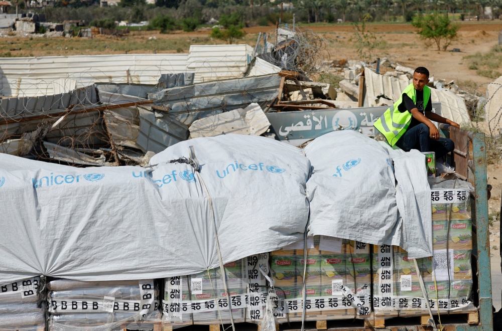 Trucks carry aid for Palestinians, in Khan Younis