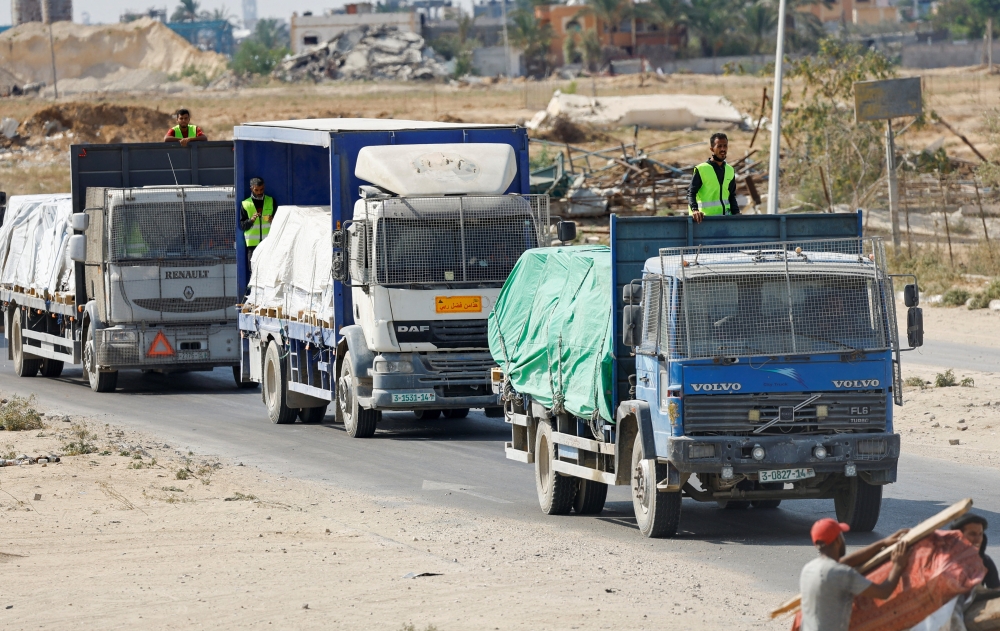 Trucks carry aid for Palestinians, in Khan Younis