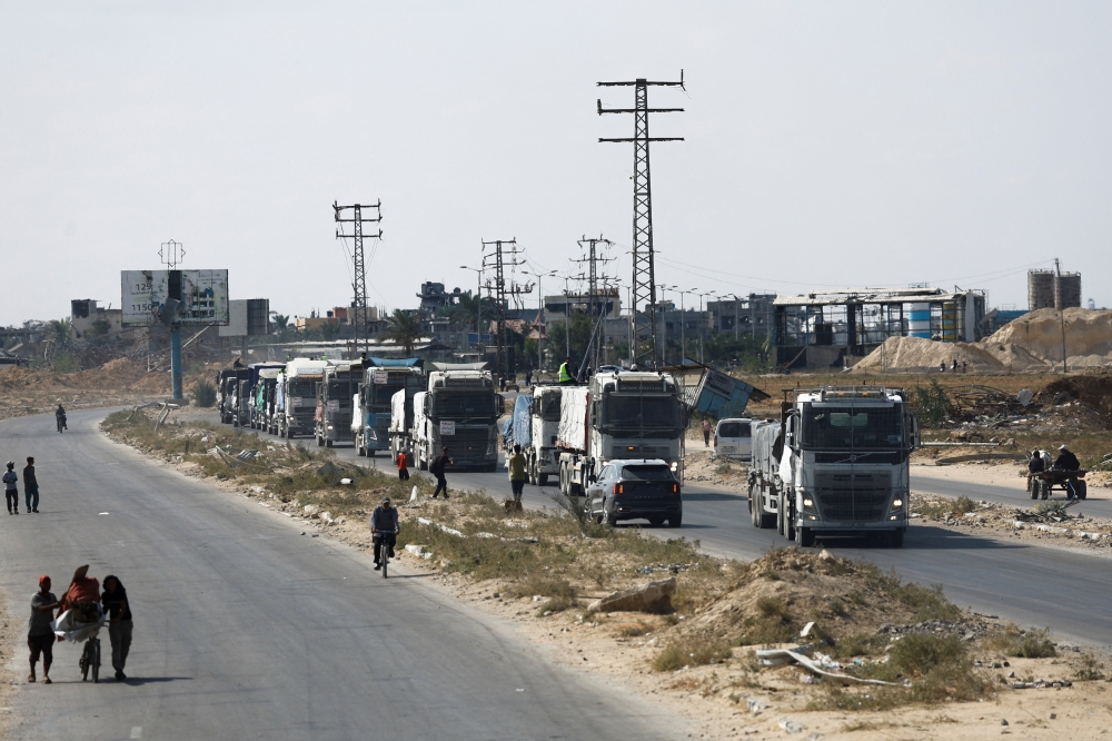 Trucks carry aid for Palestinians, in Khan Younis