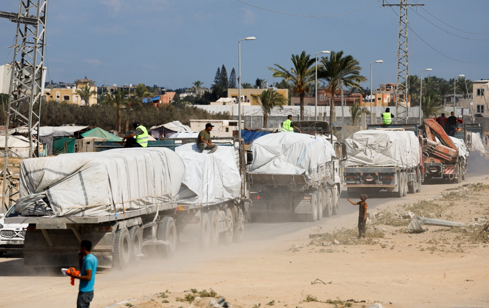 Trucks carry aid for Palestinians, in Khan Younis