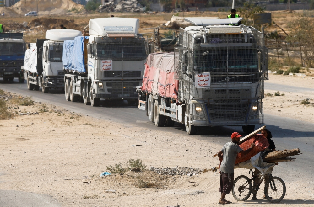 Trucks carry aid for Palestinians, in Khan Younis