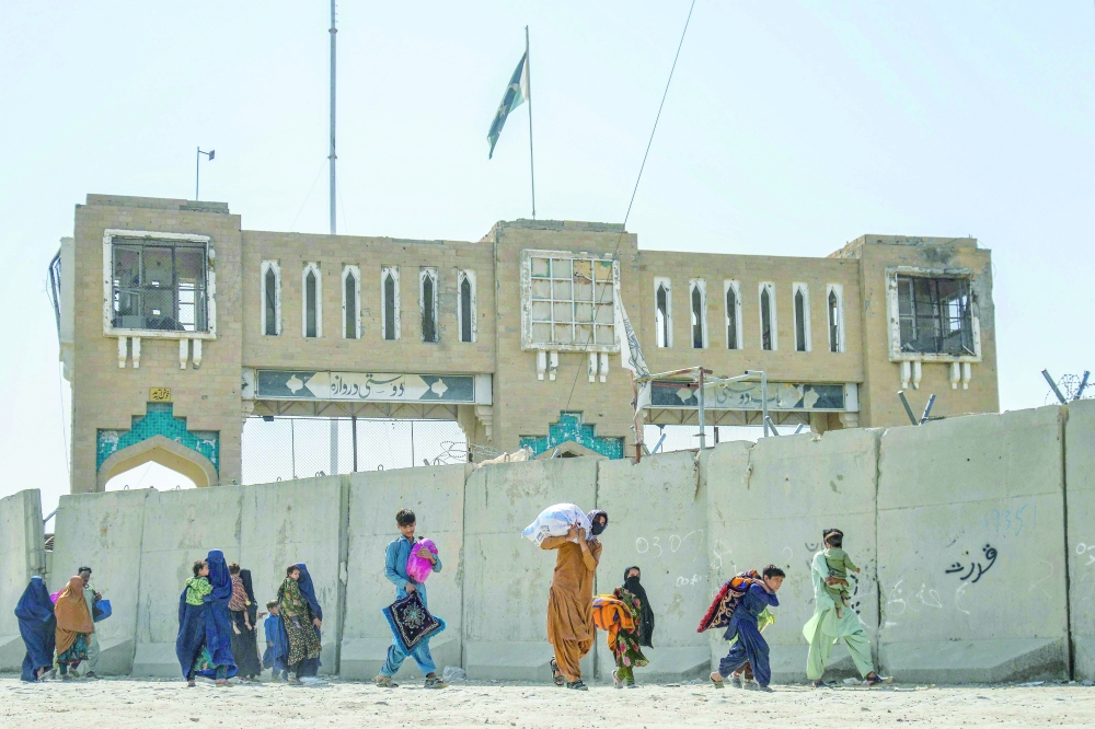 Afghan refugees deported from Pakistan arrive with their belongings at the zero point border crossing between Afghanistan and Pakistan in Spin Boldak district of Kandahar province on October 19, 2025. 