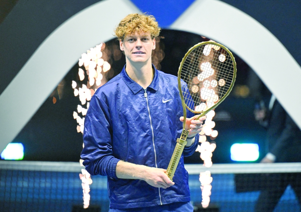 Italy's Jannik Sinner celebrates with a racket after winning the final against Spain's Carlos Alcaraz. — Reuters
