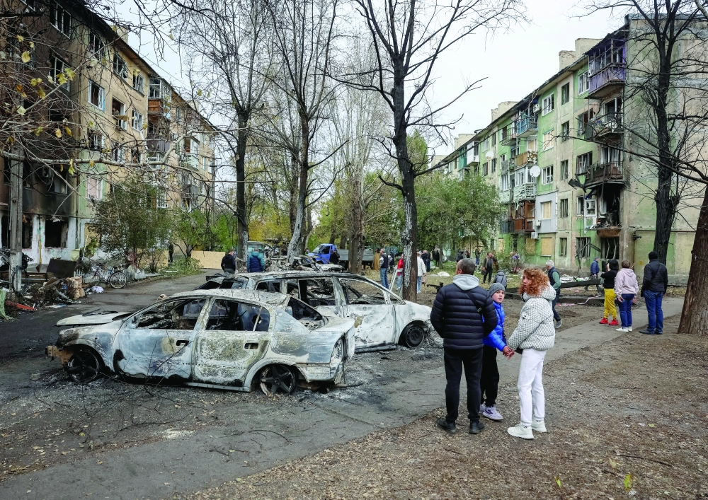 Residents stand near their apartment building hit by a Russian drone strike, amid Russia's attack on Ukraine, in the town of Shakhtarske in Dnipropetrovsk region, Ukraine. — Reuters