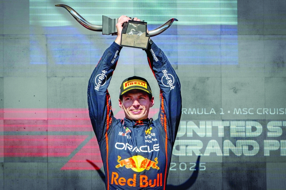 Red Bull Racing's Dutch driver Max Verstappen hoists the trophy on the podium after winning the United States Formula One Grand Prix at the Circuit of the Americas in Austin, Texas. — AFP