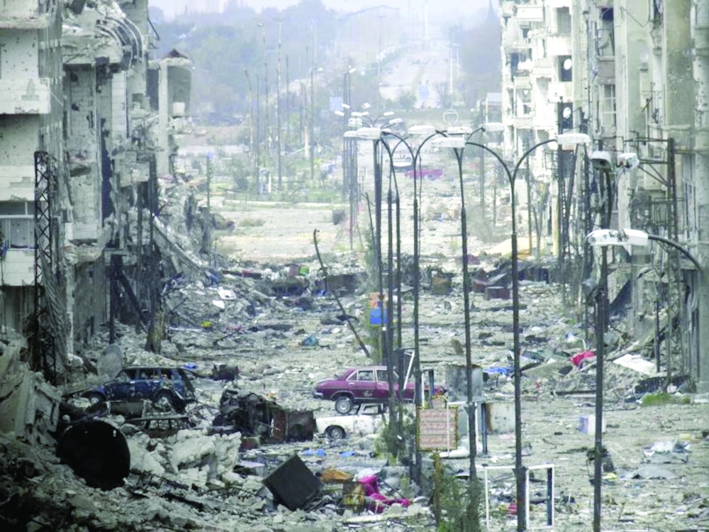 A general view of a damaged street filled with debris in Homs. — Reuters file photo