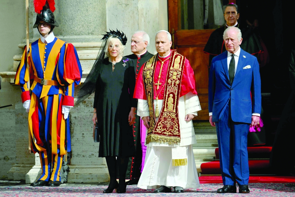 Britain's King Charles III and Britain's Queen Camilla stand with Pope Leo XIV in San Damaso courtyard during their State visit to the Vatican. — AFP