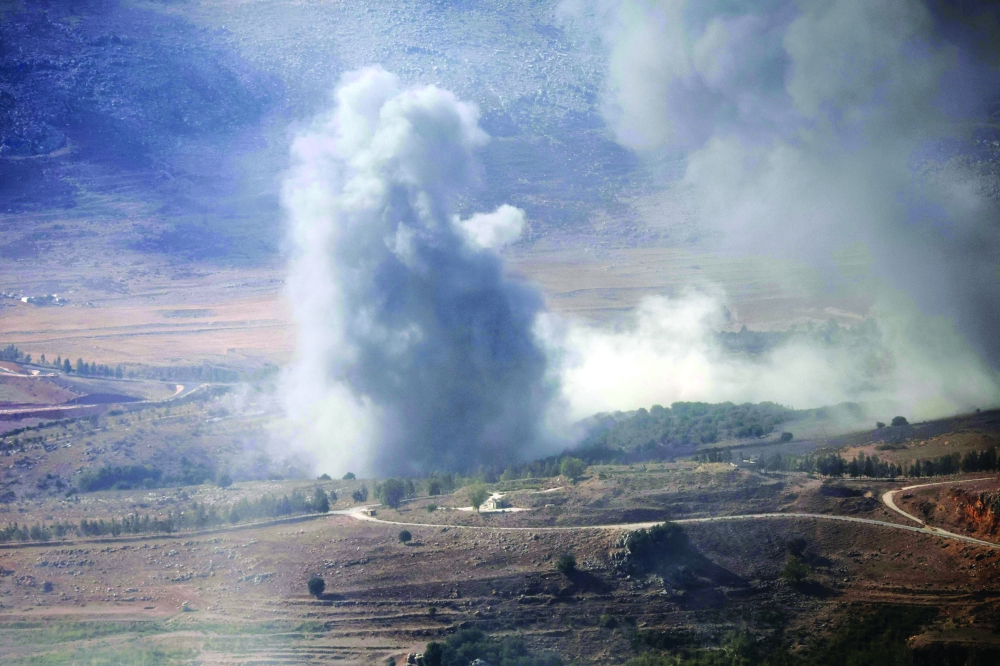 Smoke rises following an Israeli air strike, in the southern Lebanese village of Ej Jarmaq. — AFP