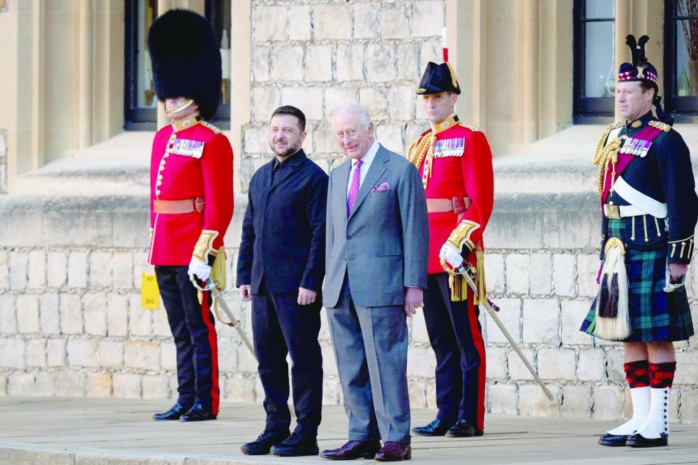 Ukraine's President Volodymyr Zelensky stands alongside Britain's King Charles III at Windsor Castle. — AFP