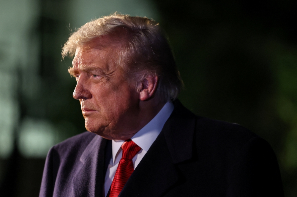 Donald Trump speaks to members of the media as he departs for Asia