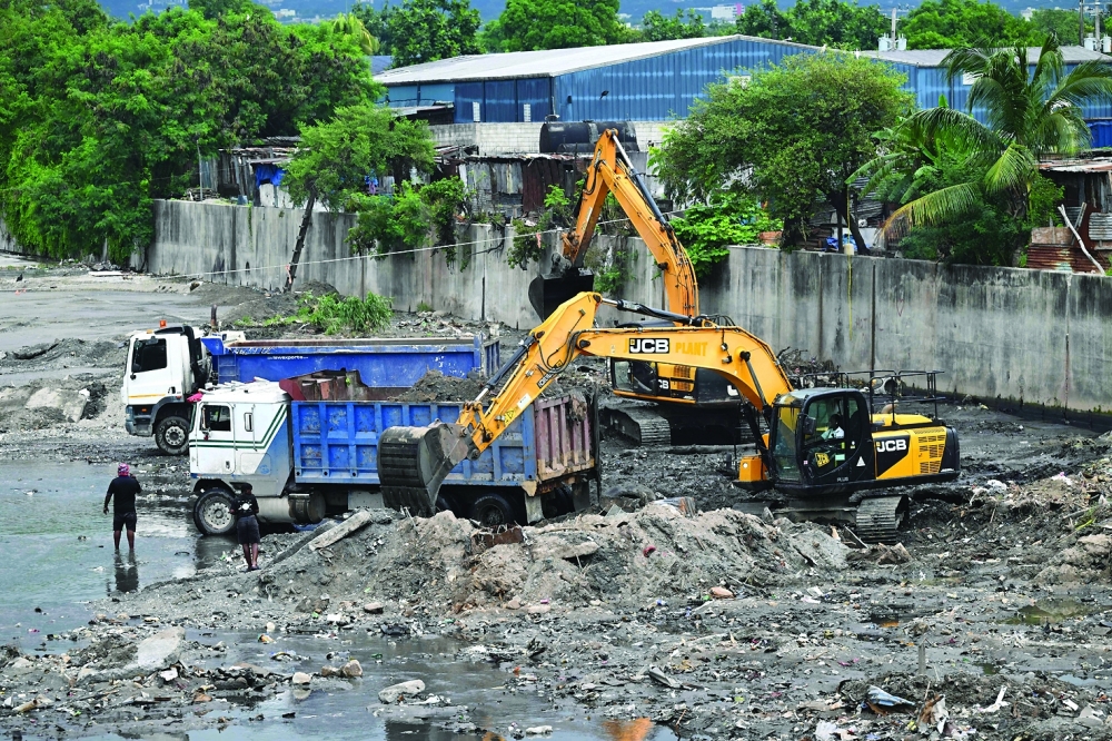 Crews clean the Sandy Gully, the main diversion channel for floodwaters in preparation for the arrival of Hurricane Melissa, just off Spanish Town road, in Kingston, Jamaica. — AFP