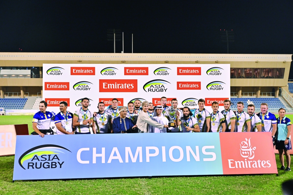  Kazakhstan players celebrate with the championship trophy. — Faisal al Balushi