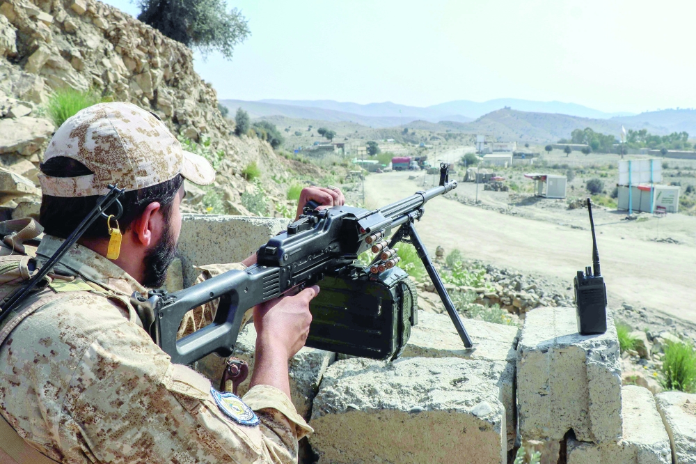 A Taliban security personnel stands guard along a road near the Ghulam Khan zero-point border crossing between Afghanistan and Pakistan in Gurbuz district in the southeast of Khost province. — AFP