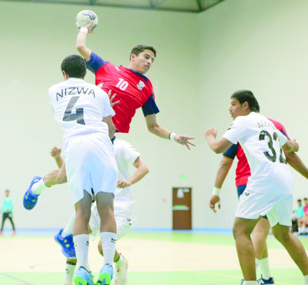 Muscat player aims towards Nizwa goal.