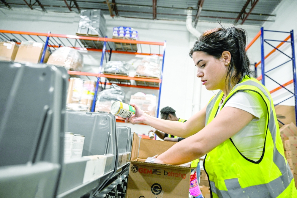 A volunteer assembles relief packages for Hurricane Melissa at the Global Empowerment Mission headquarters in Miami, Florida. — AFP