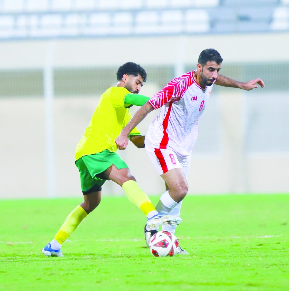 Oman Club and Al Khabourah players in action.