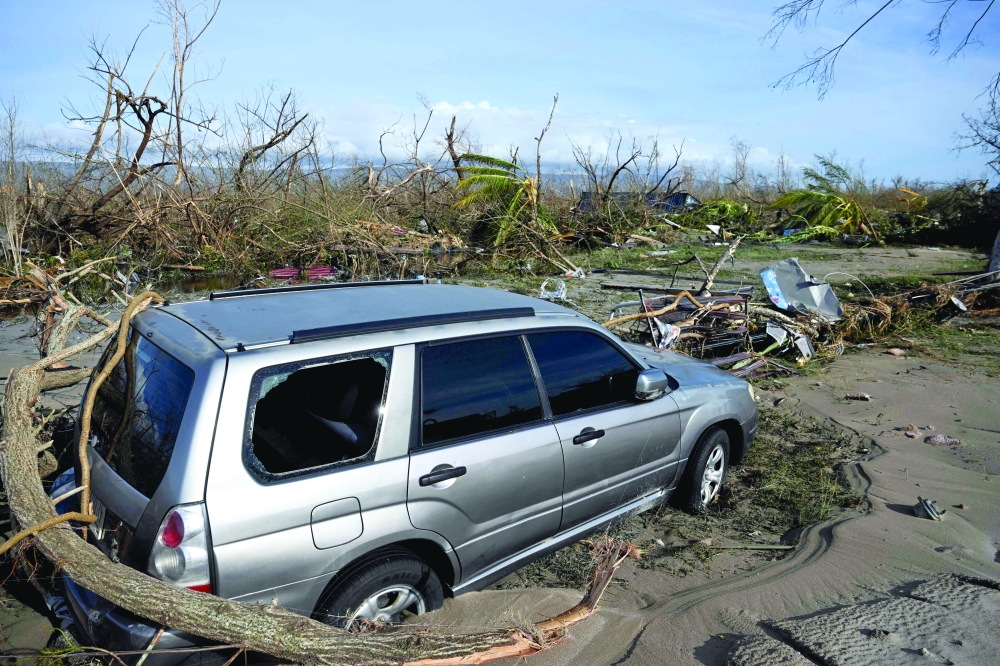 A car is seen damaged in the middle of a road following the passage of Hurricane Melissa in Black River, St Elizabeth, Jamaica. - AFP 