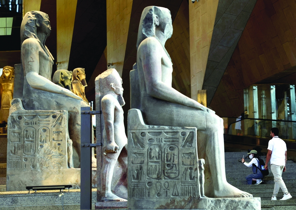 Tourists look at exhibits at the Grand Egyptian Museum (GEM), which is scheduled to officially open on November 1. — Reuters