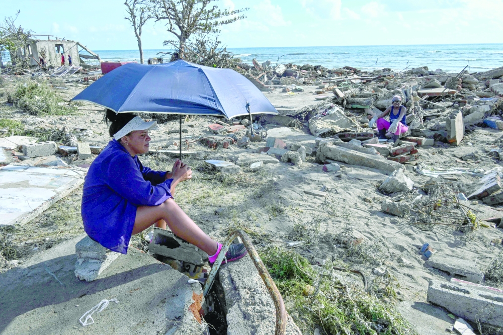 Residents rest amid debris of a damaged house after the passage of Hurricane Melissa in Boca de Dos Rios village, Santiago de Cuba province, Cuba. - AFP
