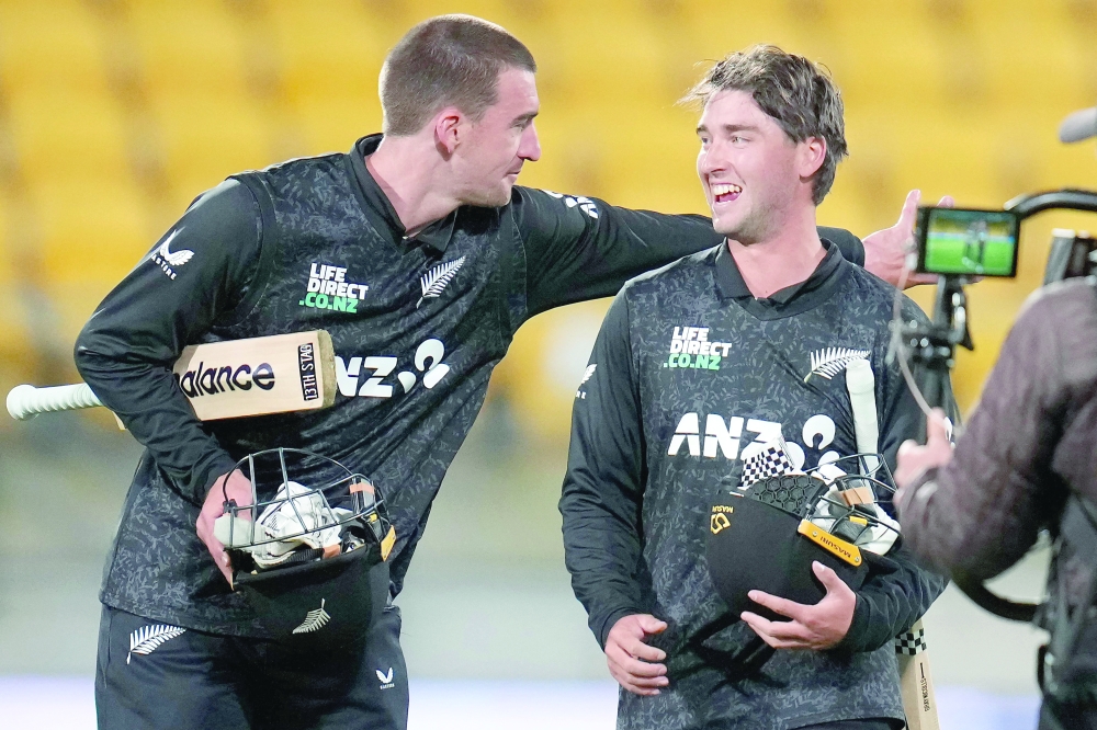 New Zealand's Blair Tickner (L) celebrates with teammate Zak Foulkes after their win in the third one-day international (ODI) cricket match. — AFP