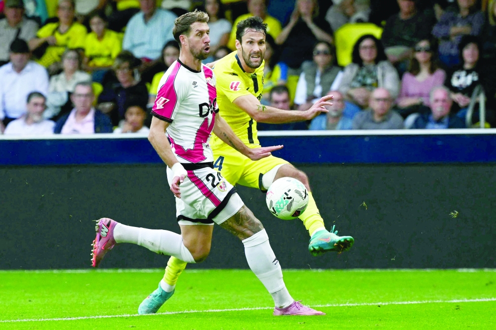 Villarreal's Spanish defender #24 Alfonso Pedraza (R) shoots the ball past Rayo Vallecano's French defender #24 Florian Lejeune. — AFP