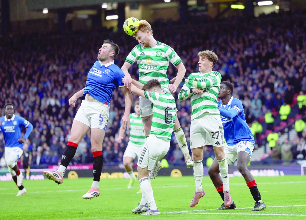 Celtic's Liam Scales in action with Rangers' John Souttar. — Reuters