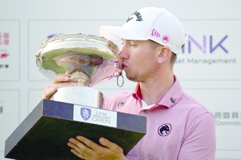 Tom McKibbin celebrates with the Hong Kong Open trophy.
