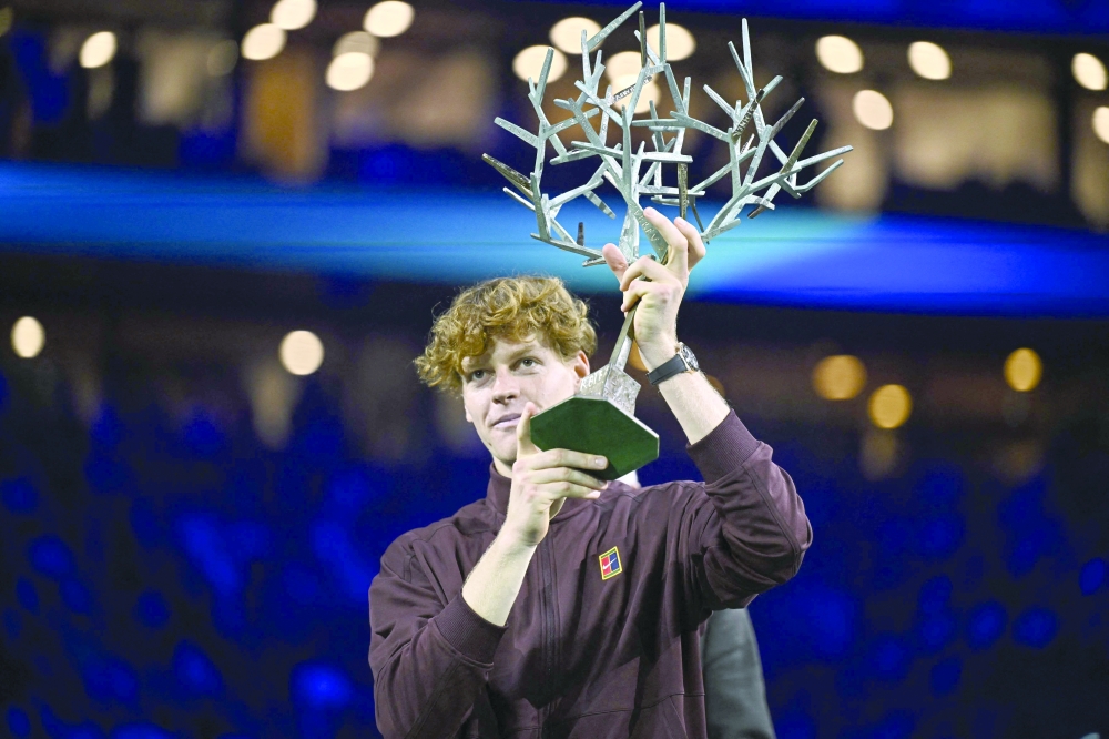 Italy's Jannik Sinner celebrates with the trophy after winning the men's singles final match of the Paris ATP Masters 1000 tennis tournament. — AFP 