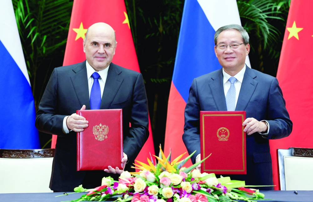 Chinese Premier Li Qiang, Russian PM Mikhail Mishustin take part in a signing ceremony, in Hangzhou. — Reuters