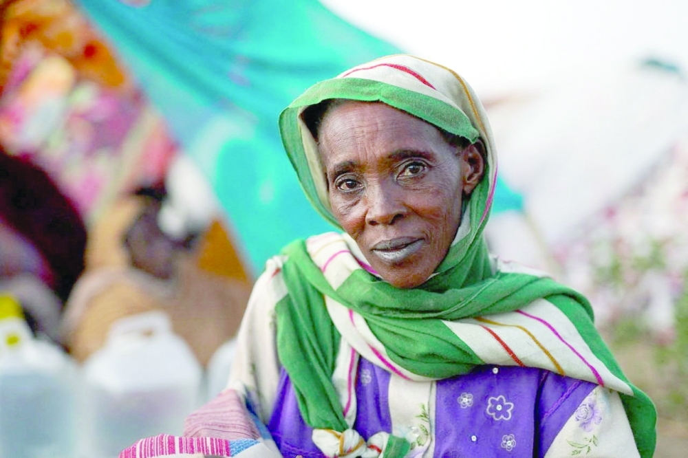 A displaced woman looks on while sitting at a camp, in North Darfur, Sudan. — Reuters